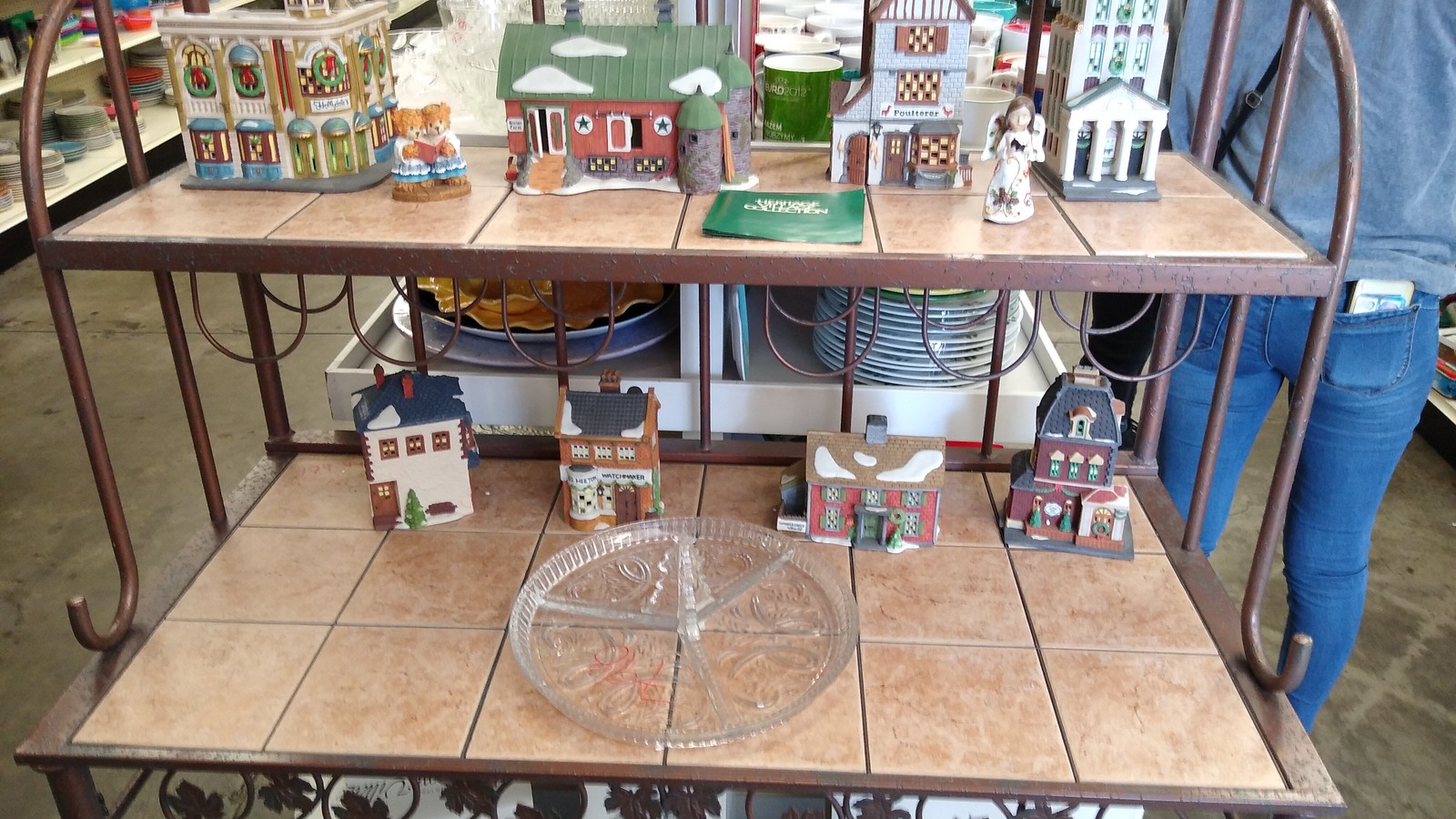Miniature houses and tabletop decor arranged on a wooden table