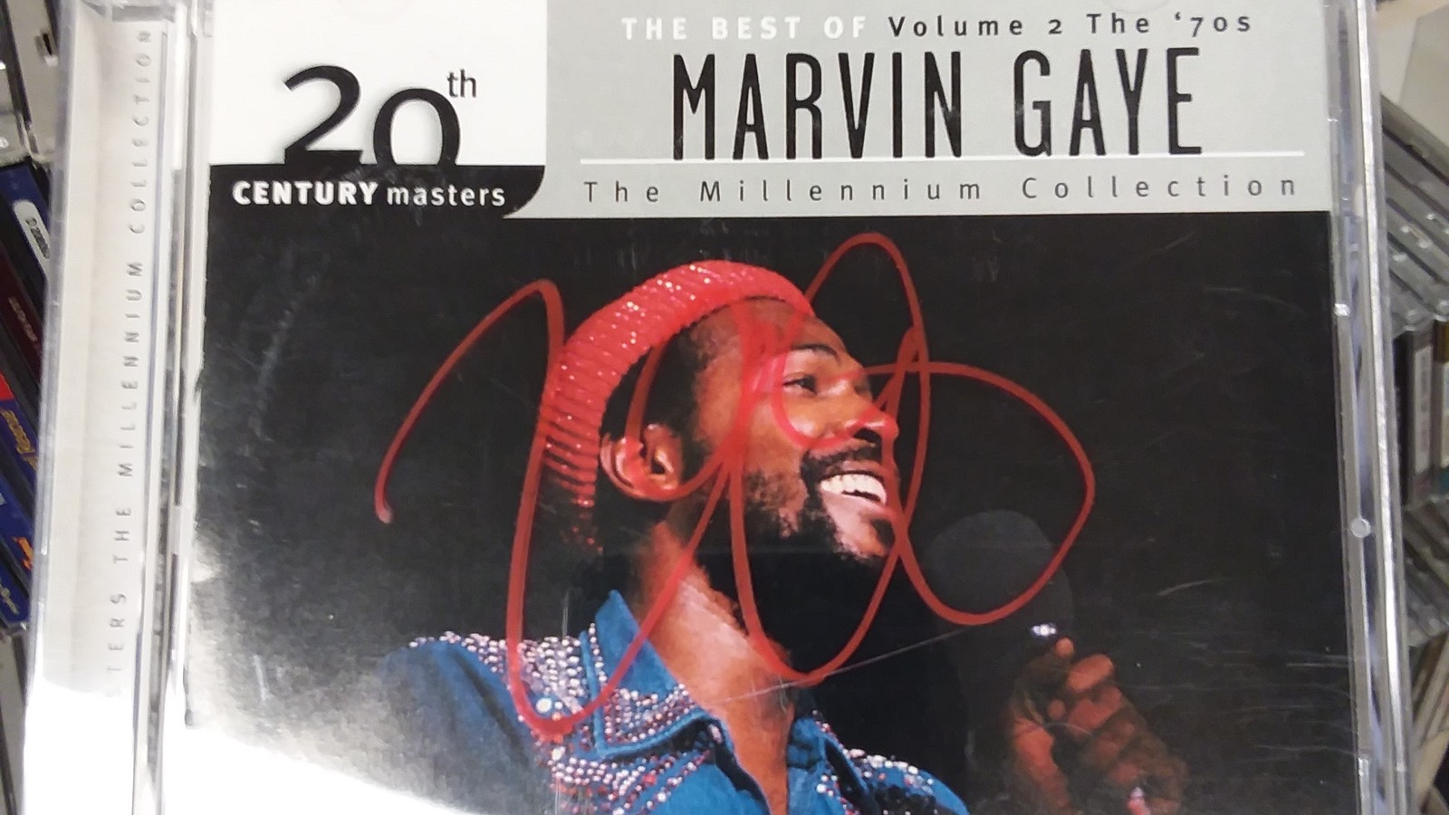 Marvin Gaye CD in front of rows of secondhand music