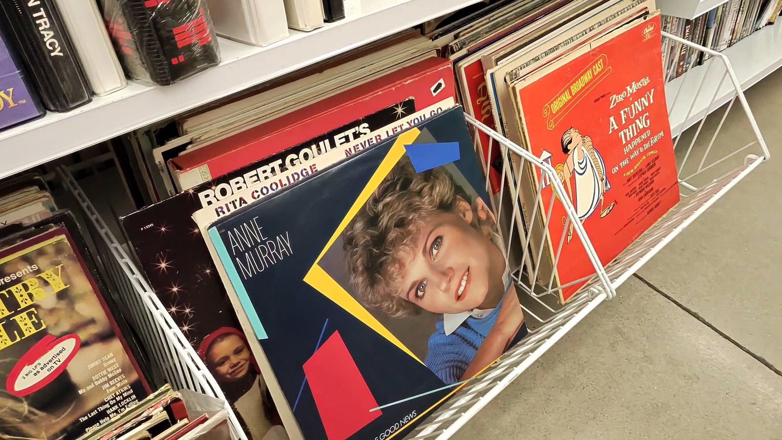 Colorful record albums organized in wire racks