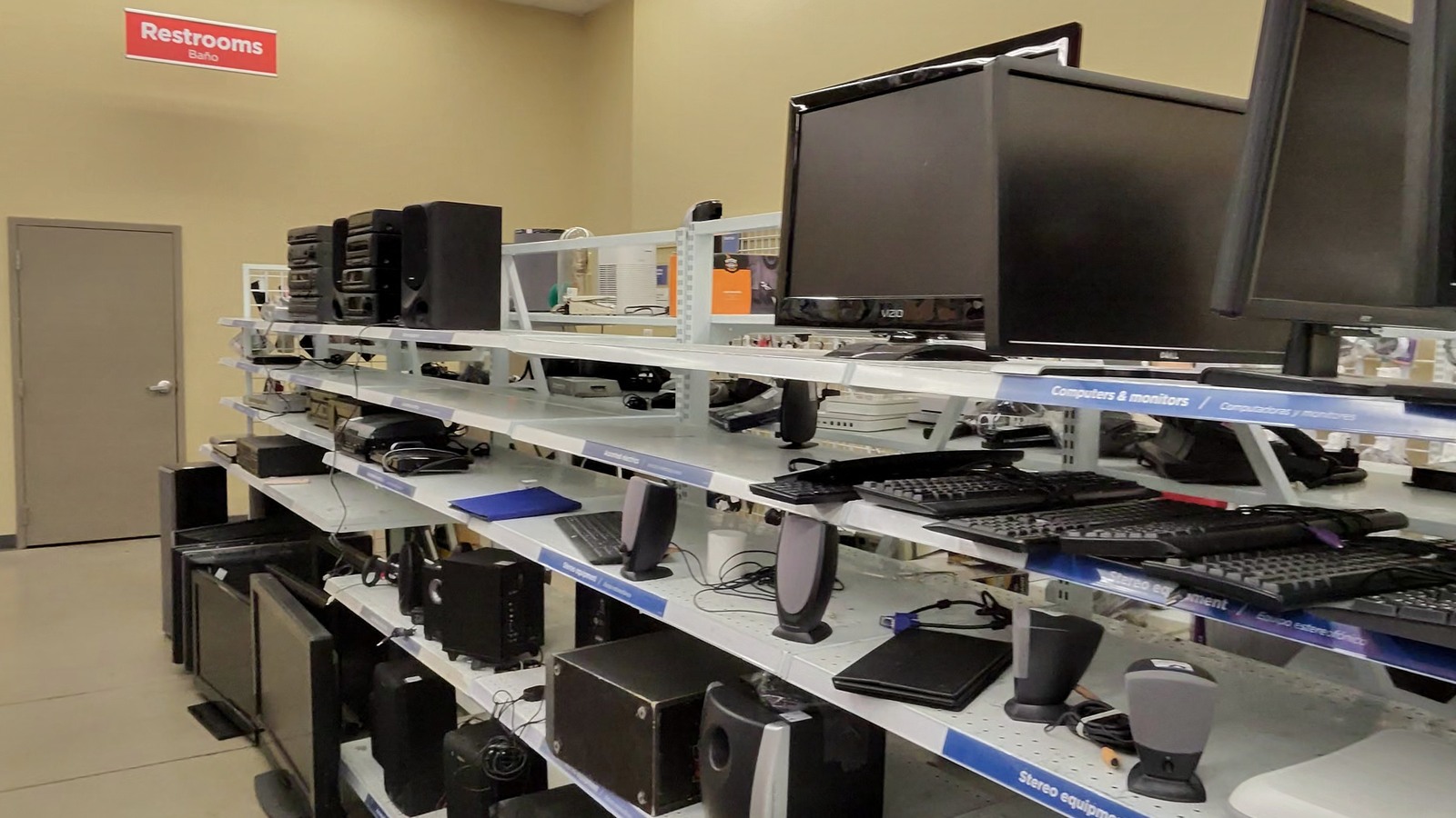 Computer monitors and electronics arranged on store shelves