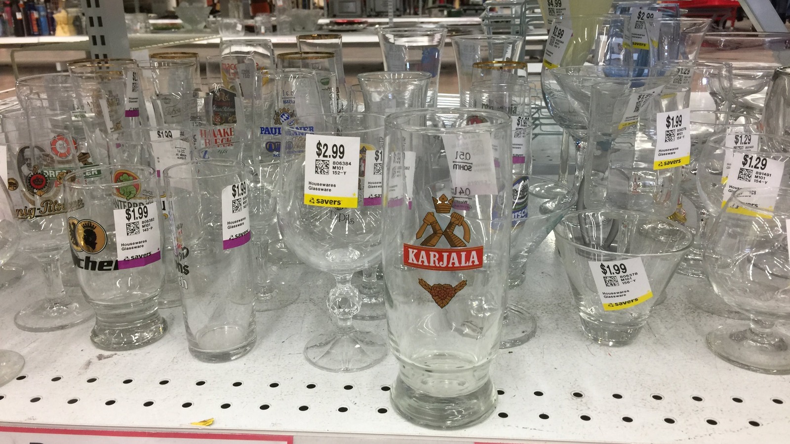 Clear and decorated glassware lined up on a housewares shelf
