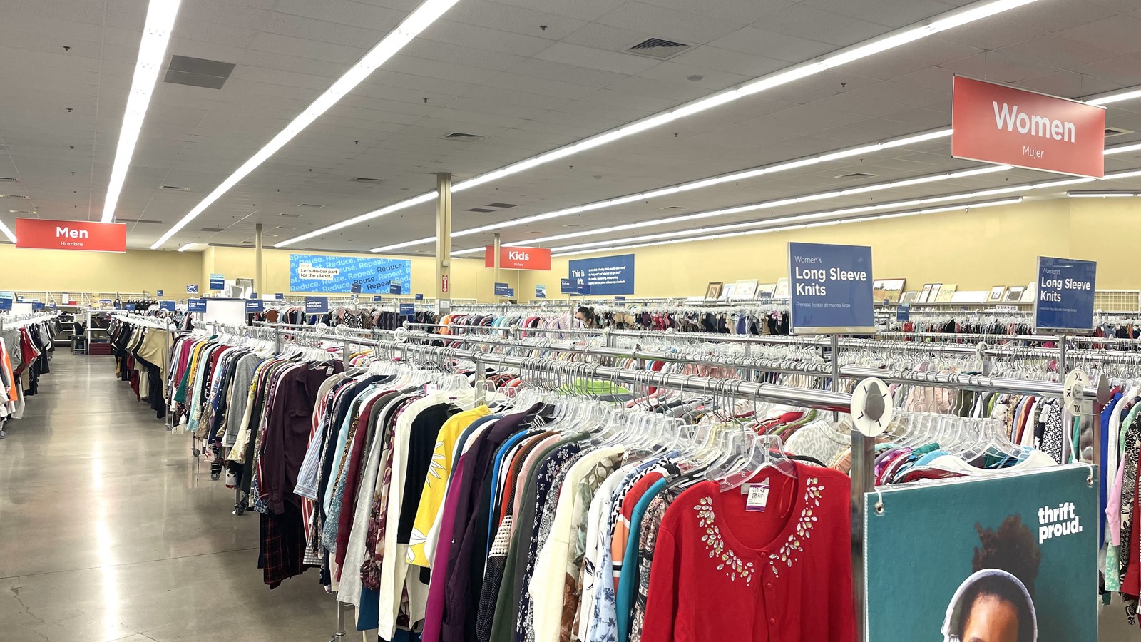 Colorful shirts stretching across long organized clothing racks