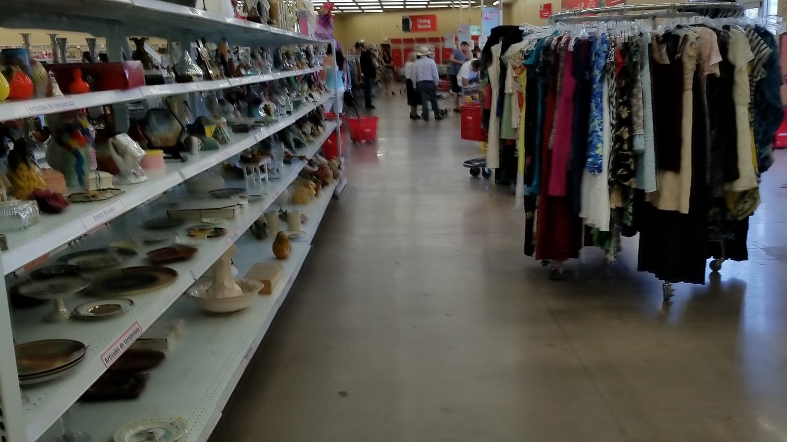 Shoe shelves facing colorful clothing racks at Savers