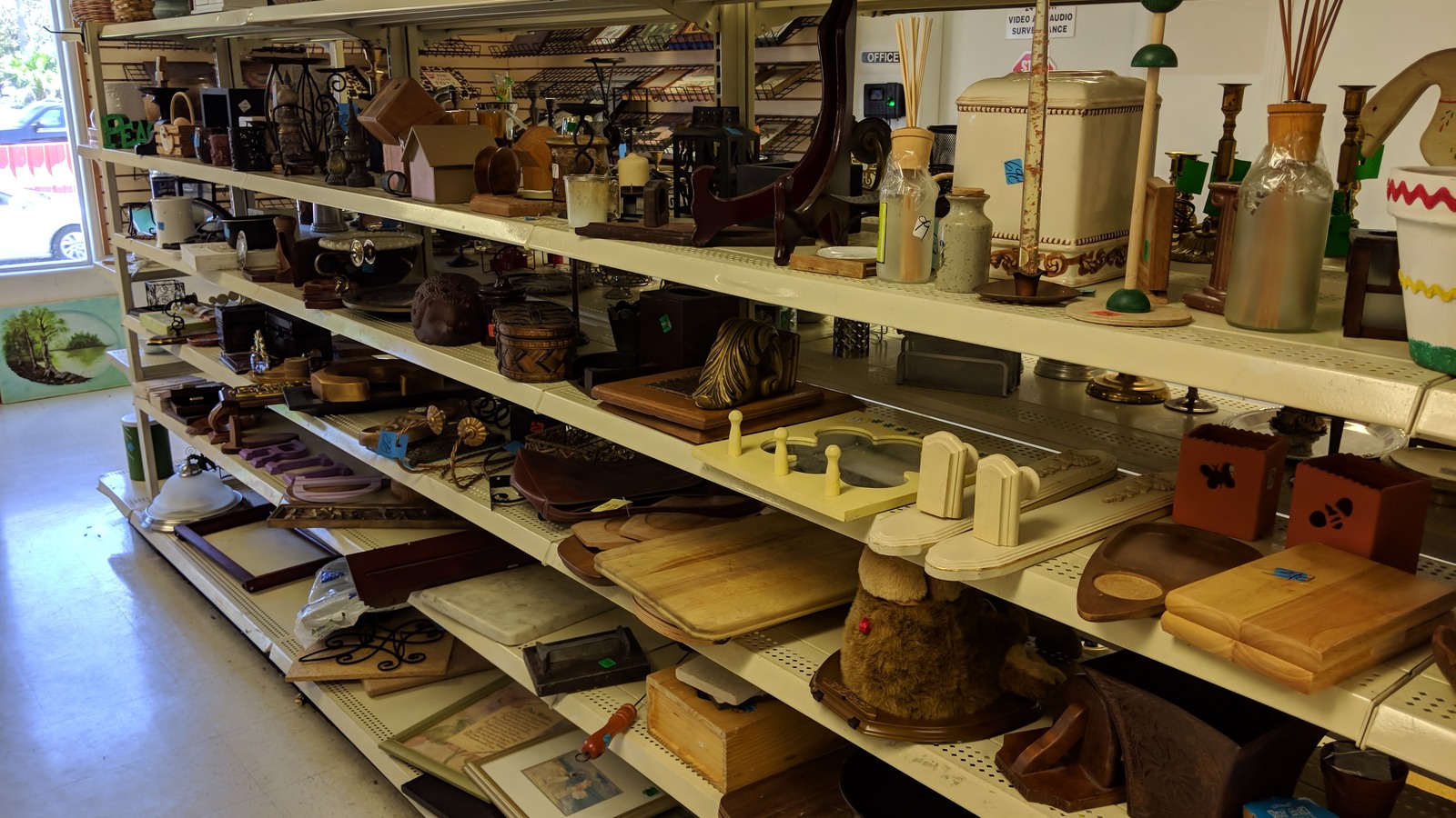 Shelves filled with secondhand housewares and decorative pieces
