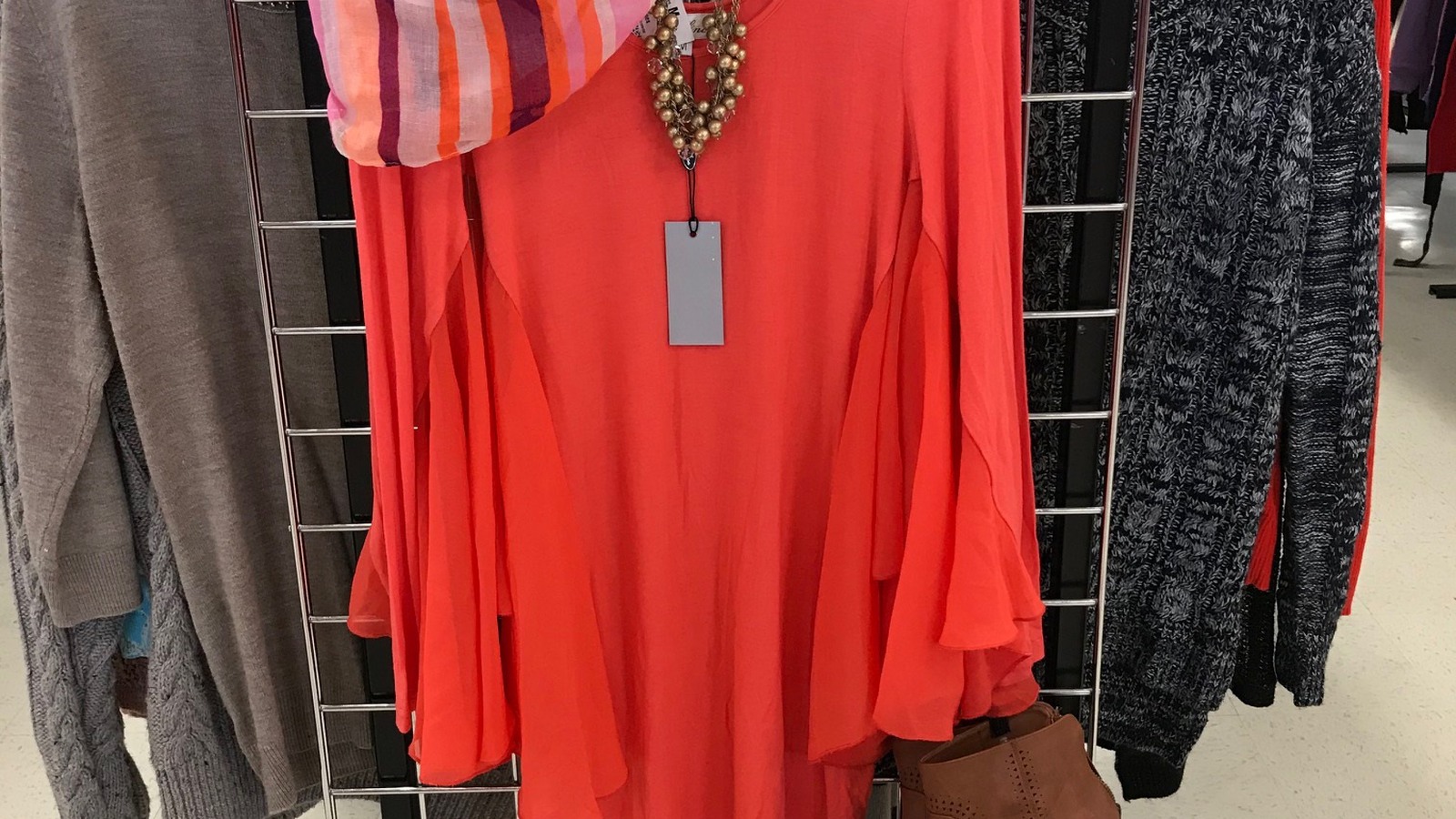 Bright red dress and patterned clothing on a McAllen thrift-store rack
