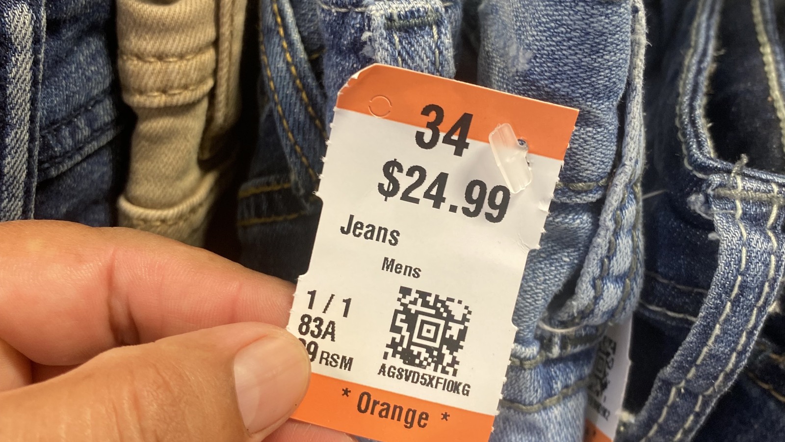 Orange color tag attached to secondhand jeans in McAllen