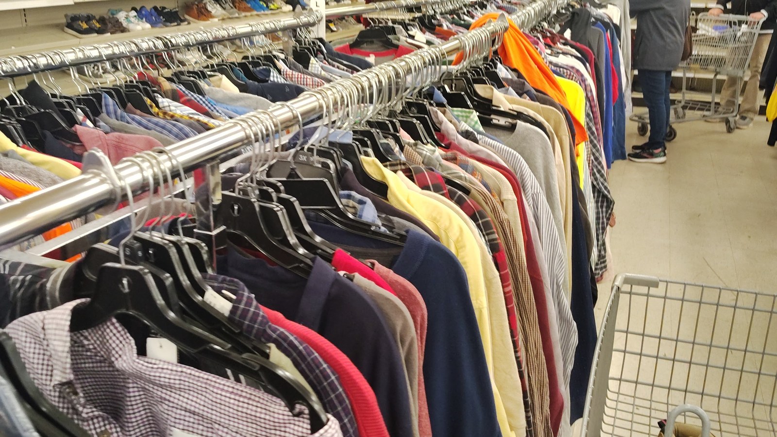 Shirts, jackets, and other garments filling a clothing rack