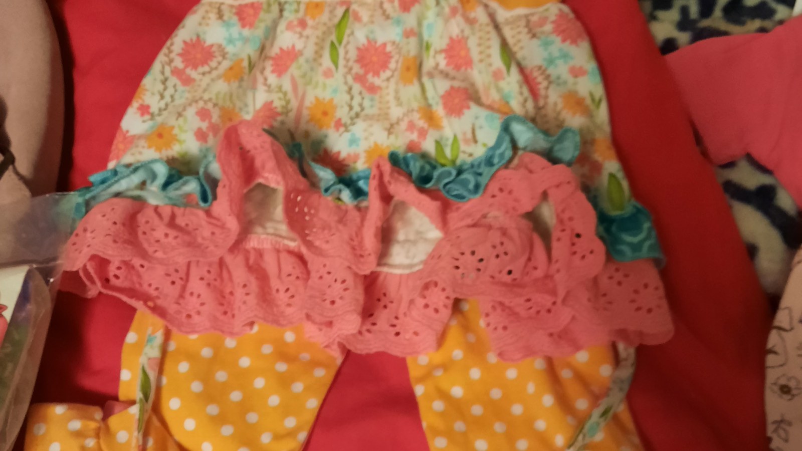 Colorful children's clothing with ruffles and playful patterns