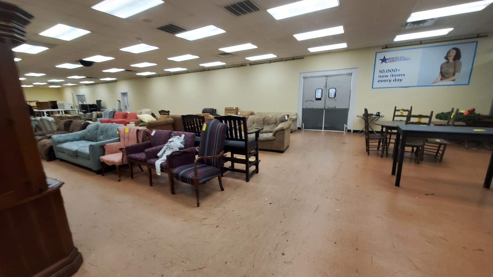 Sofas, dining tables, chairs, and shelving across a roomy showroom