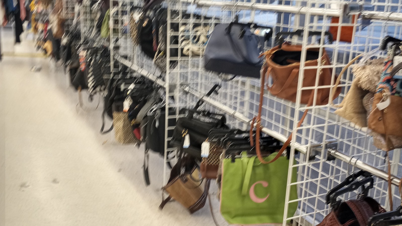 Handbags, belts, scarves, and accessories on metal displays