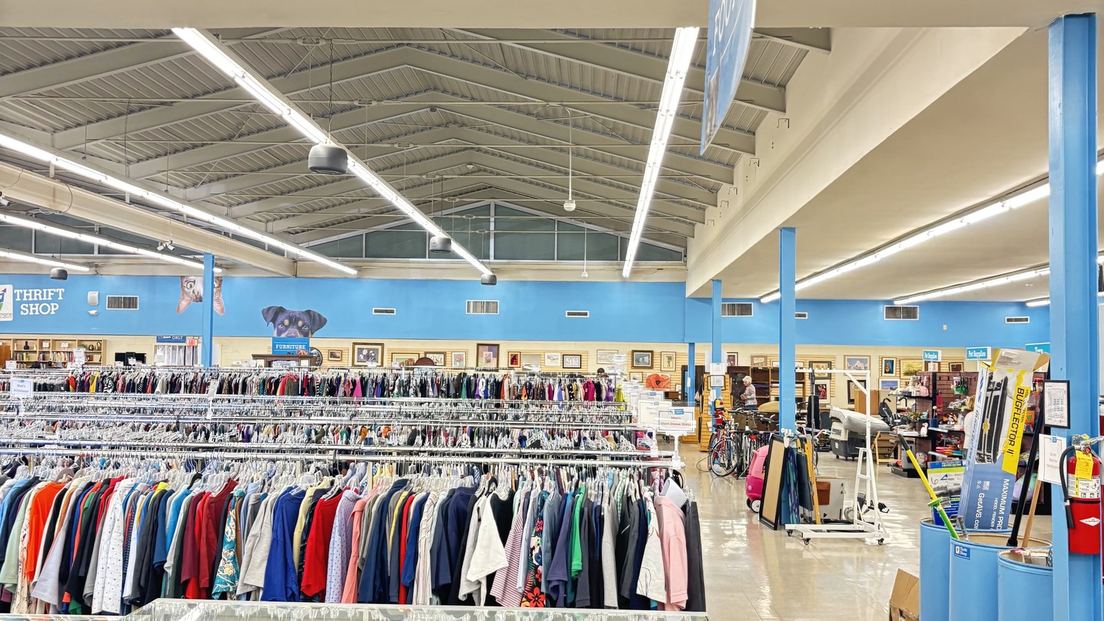 Wide clothing floor with organized racks at Animal Humane Thrift Store