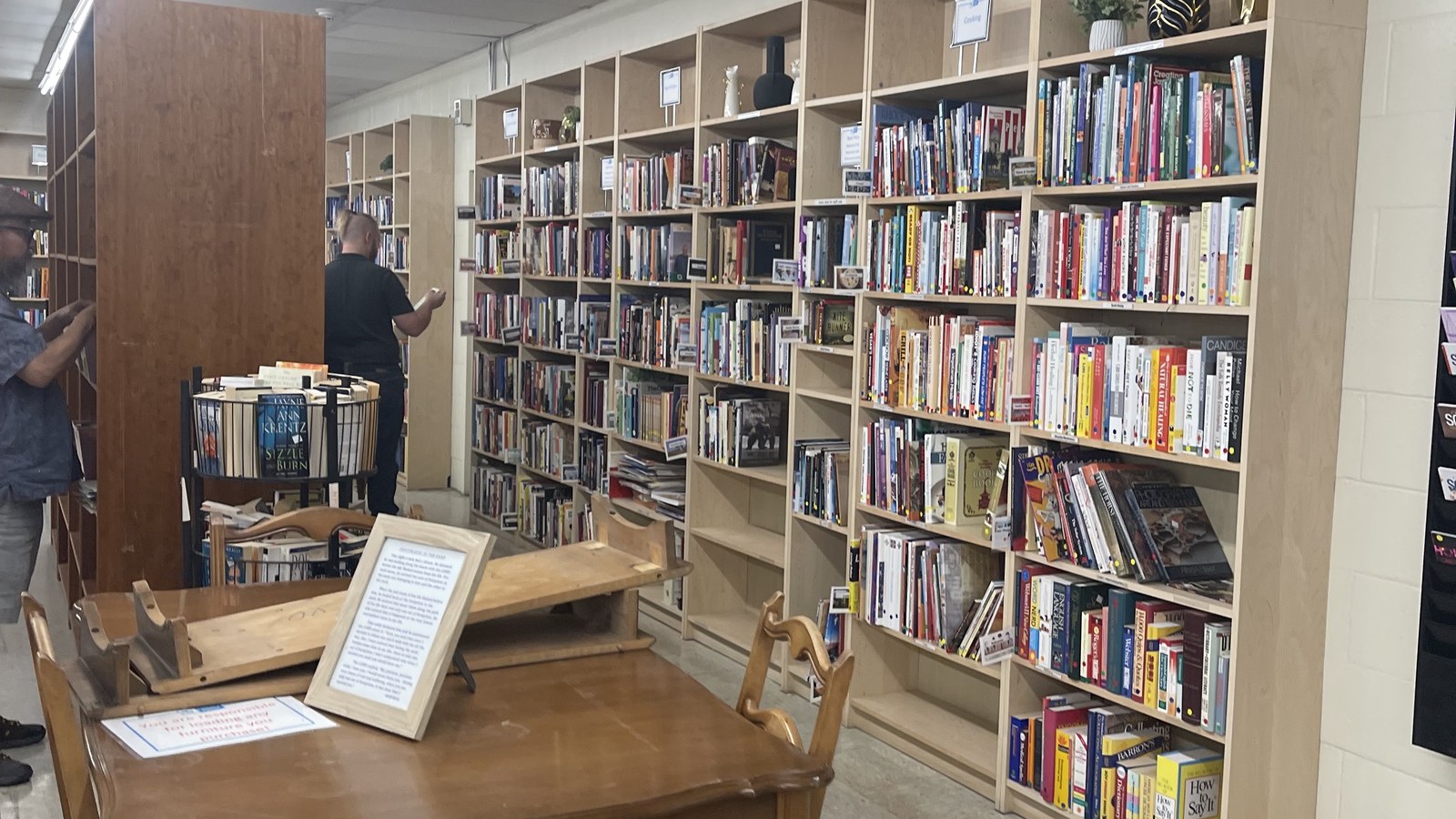 Tall shelves filled with books in the Albuquerque thrift shop