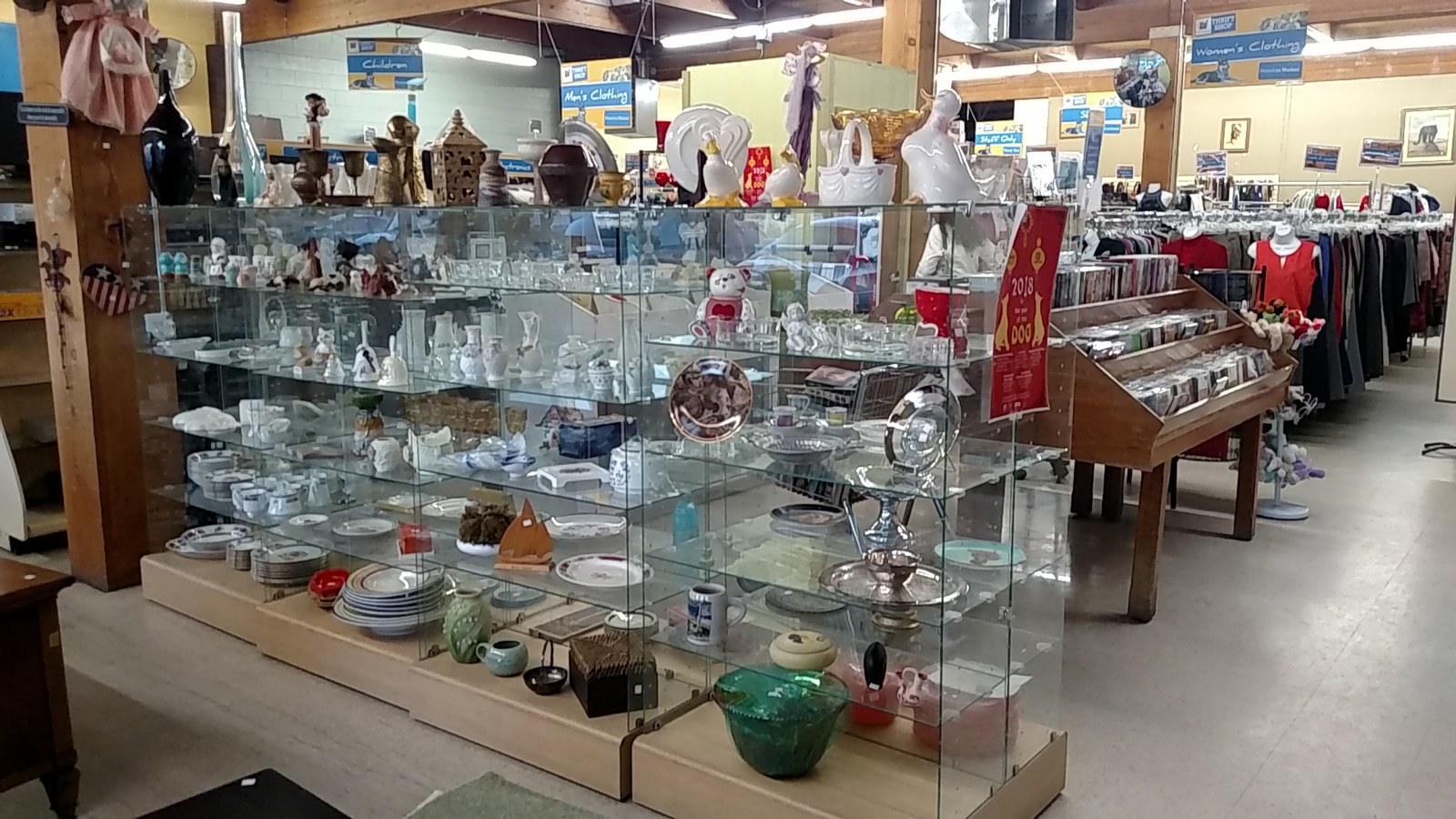 Glass display cases filled with serving pieces and collectibles