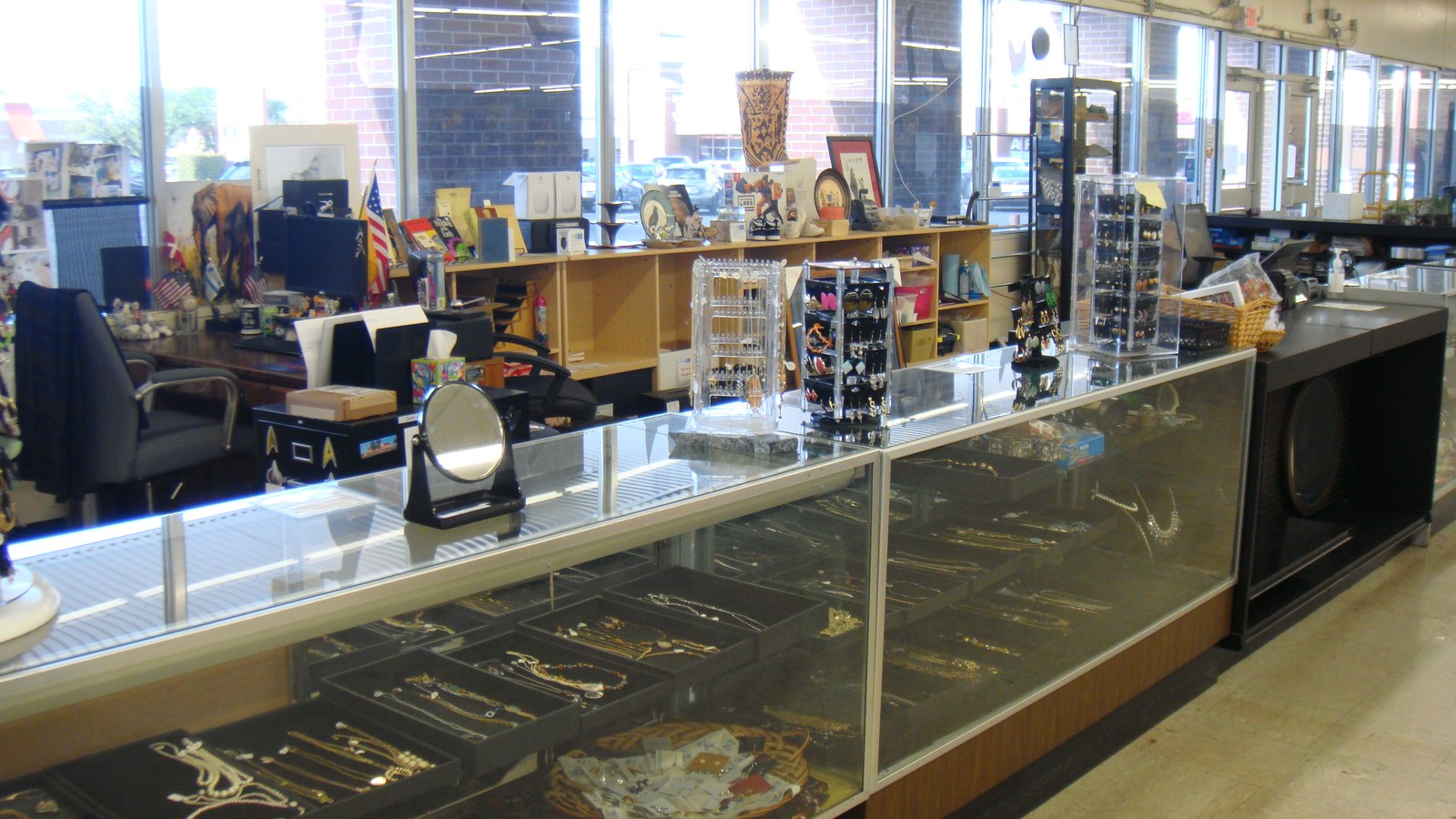 Necklaces, bracelets, and small accessories in glass jewelry cases