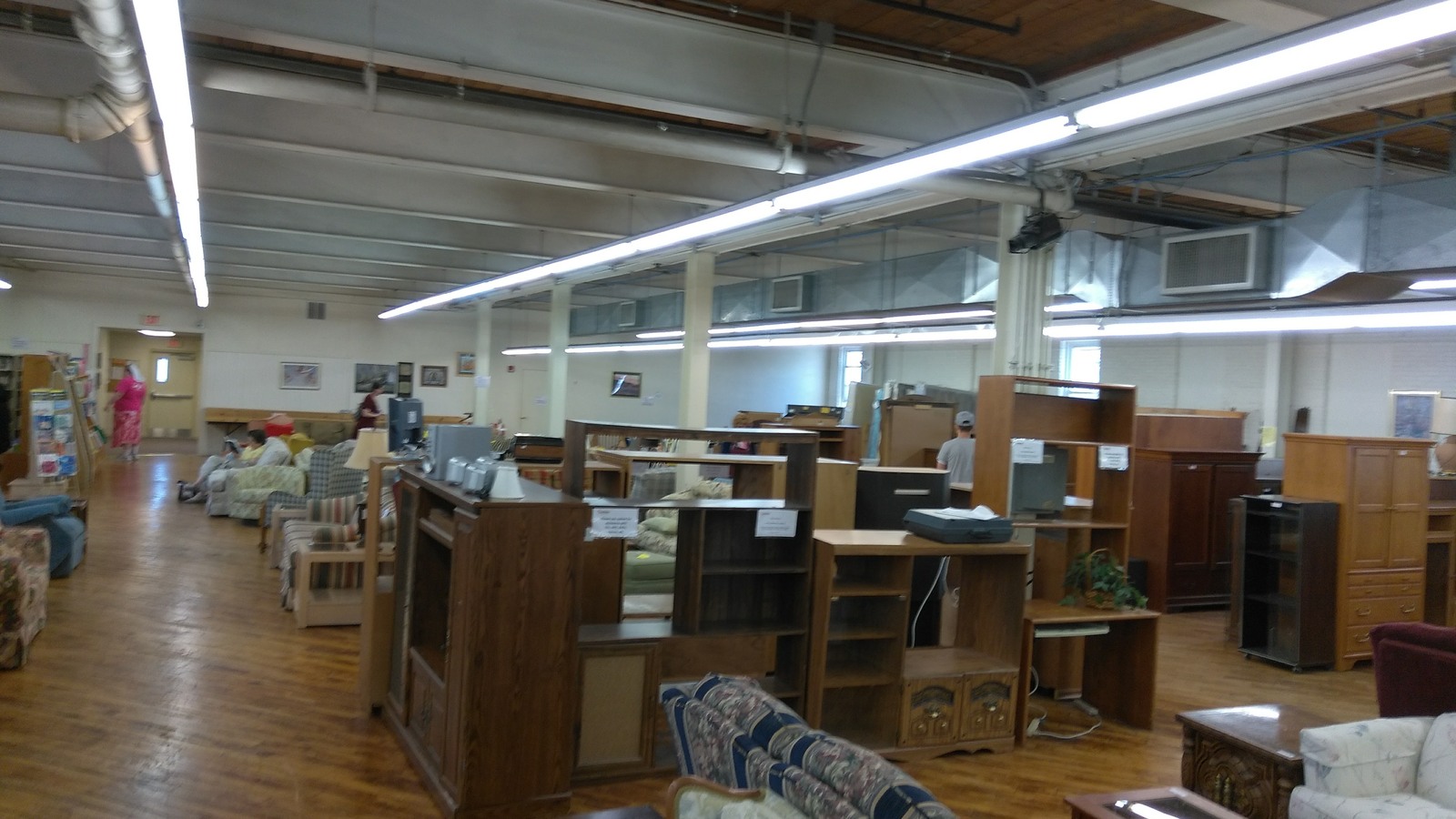 Wooden desks, shelves, and furniture across Jubilee's upper floor