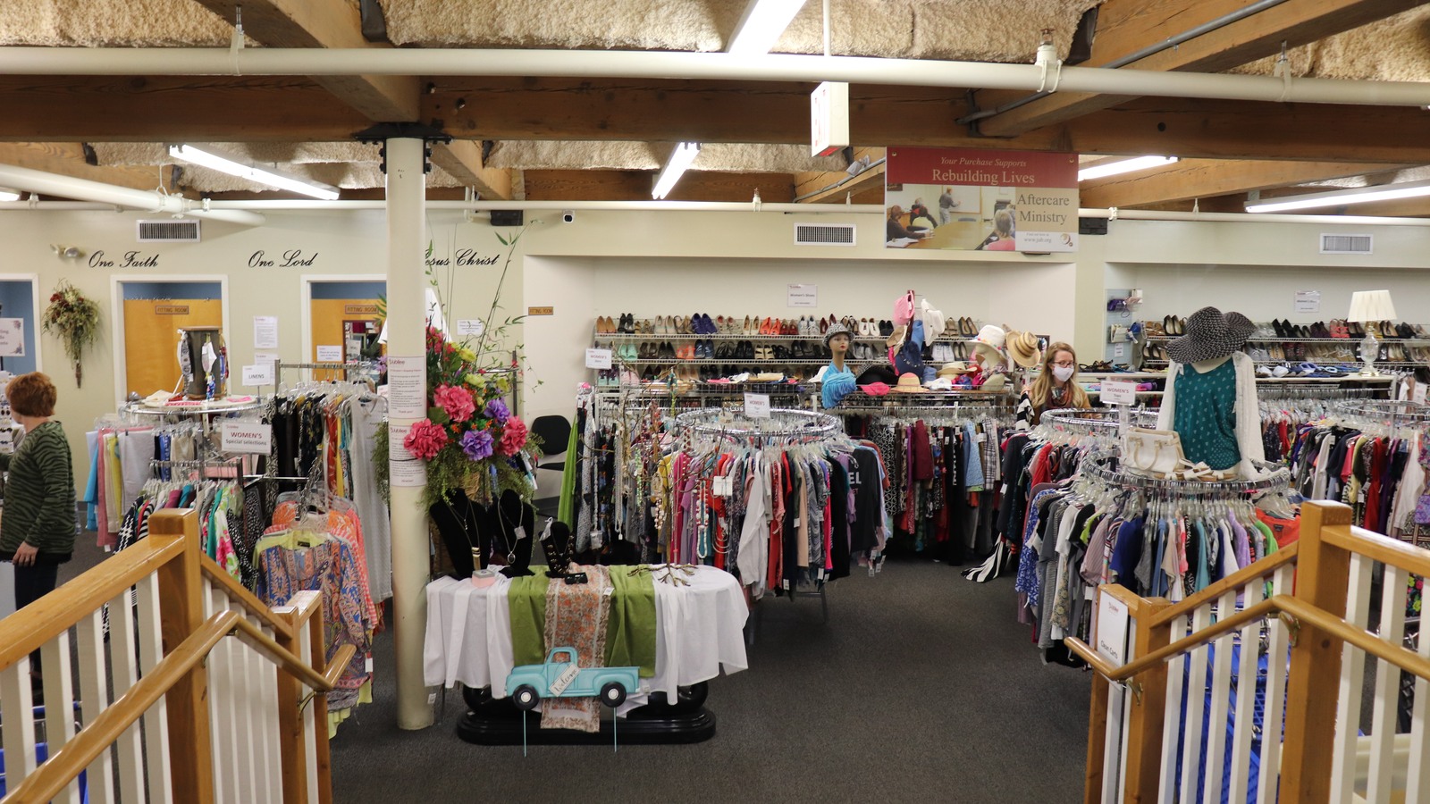 Clothing racks and display tables across the first-floor apparel store