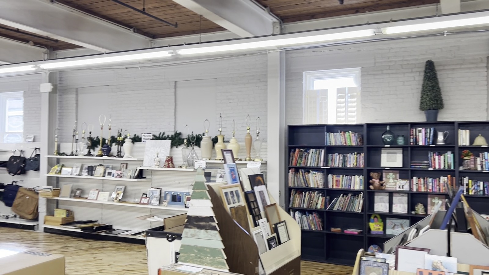 Books, frames, bottles, and small home pieces arranged on shelves