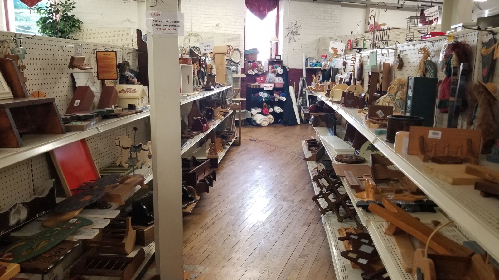Long housewares aisle with trays, frames, baskets, and decorative pieces