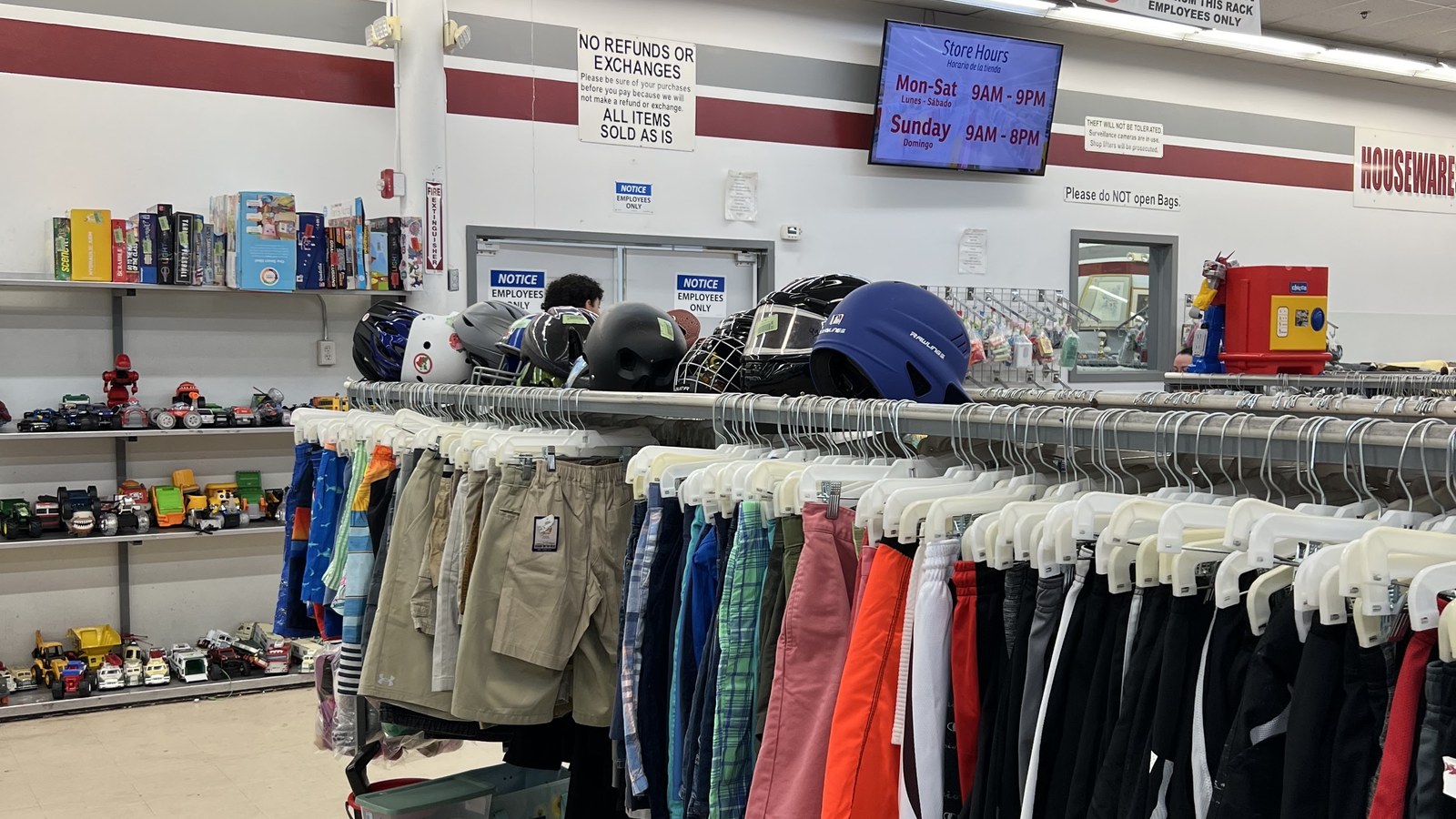 Colorful clothing rack with collectibles arranged along the wall