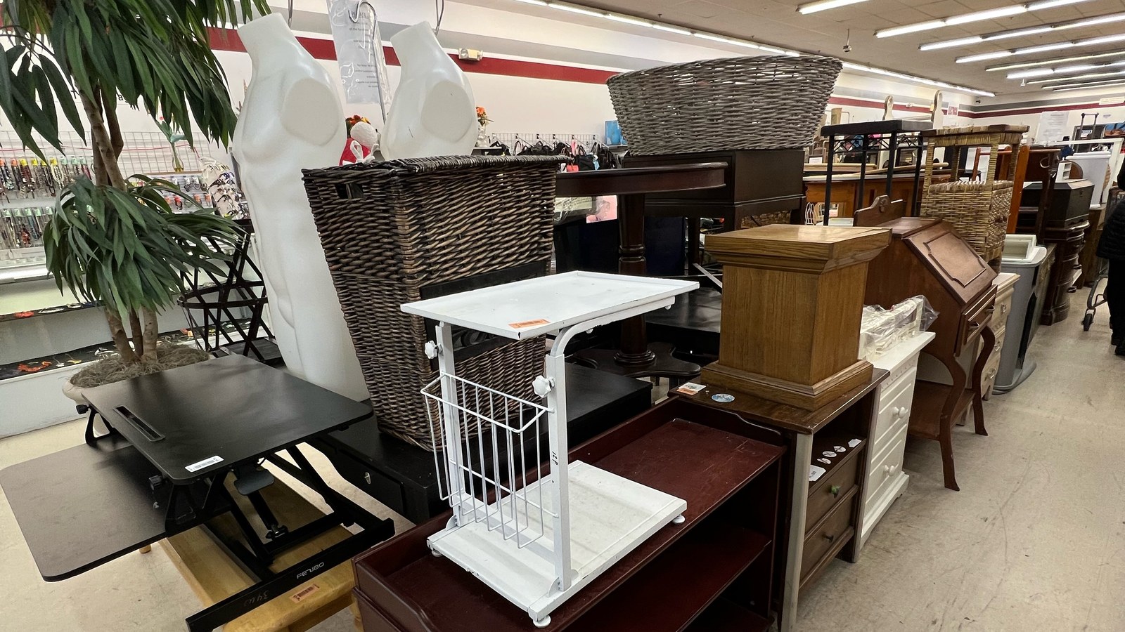 Tables, chairs, cabinets, and small furniture across the sales floor