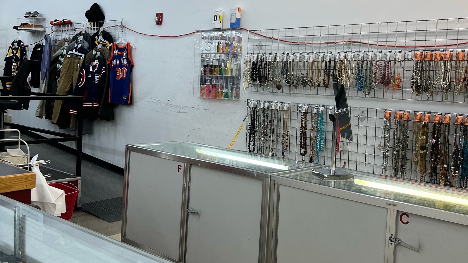 Necklaces and small accessories displayed beside a glass counter