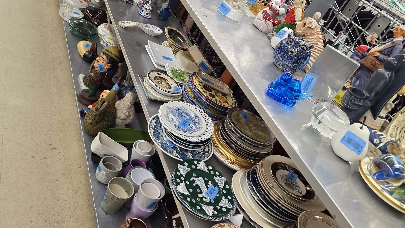 Stacks of dishes, mugs, pottery, and blue-and-white ceramics