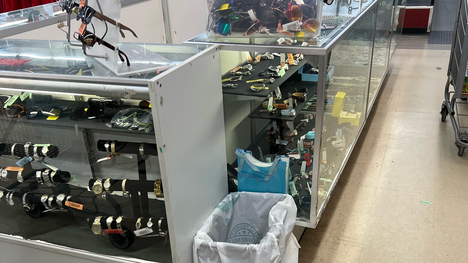Watches and small accessories arranged inside a glass case