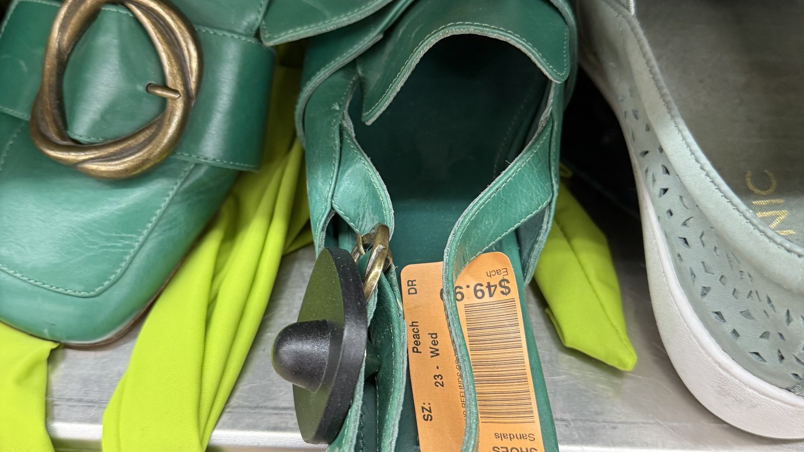 Green flats and white shoes with colored sale tags
