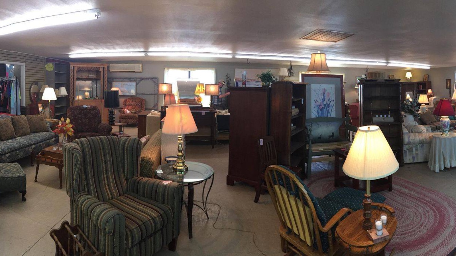 Sofas, armchairs, tables, and lamps across the furniture showroom at Renewed Hope Thrift Store in Murphy