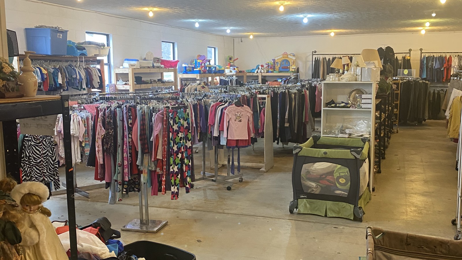 Children's clothing racks and household goods inside Community Chest Thrift Store in Maryville