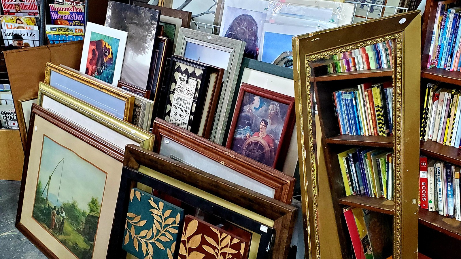 Framed art and books arranged inside 4 Chics and a Cat in Maryville
