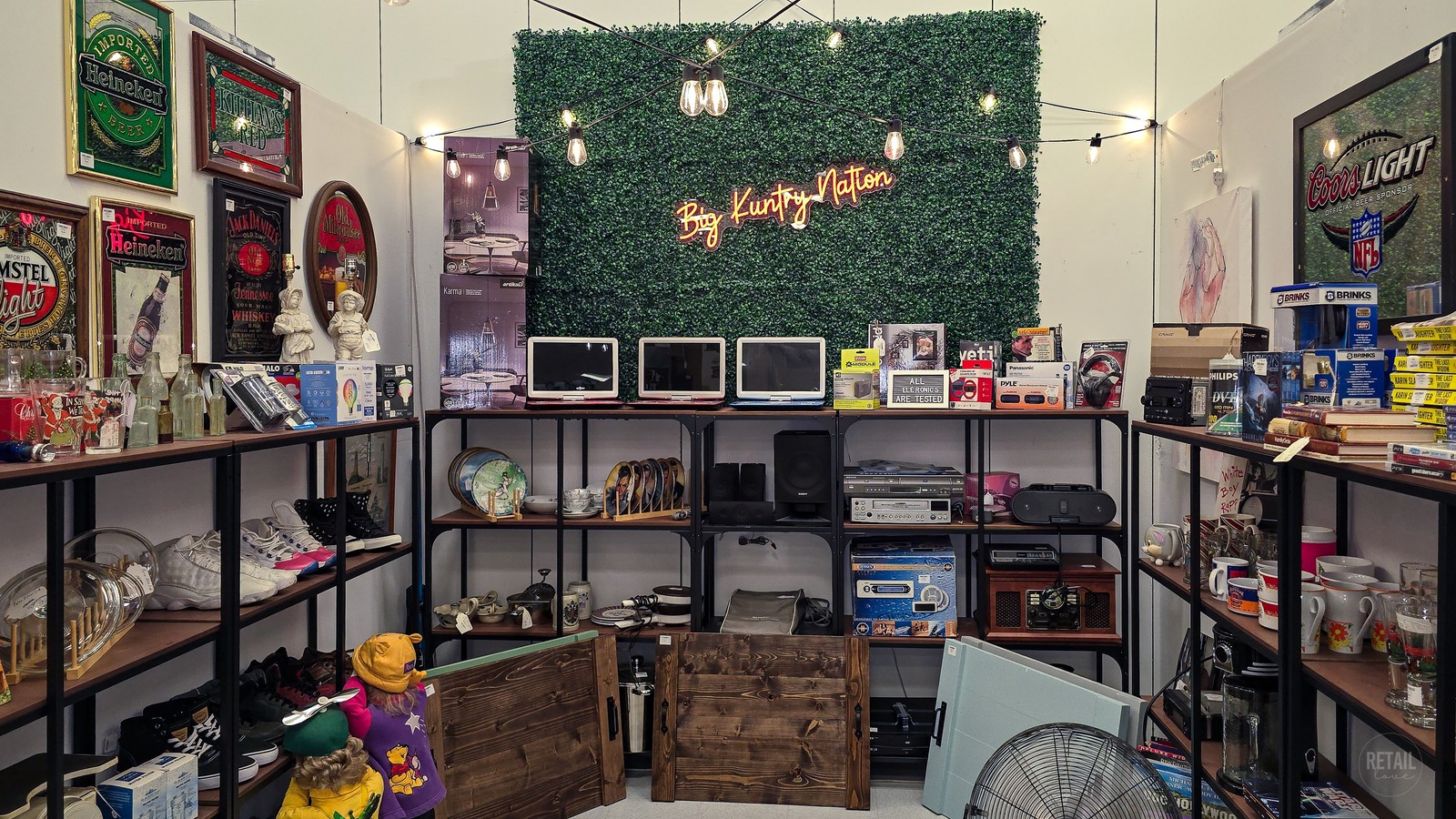 Vintage signs and collectibles arranged in a Titusville Antique Mall booth