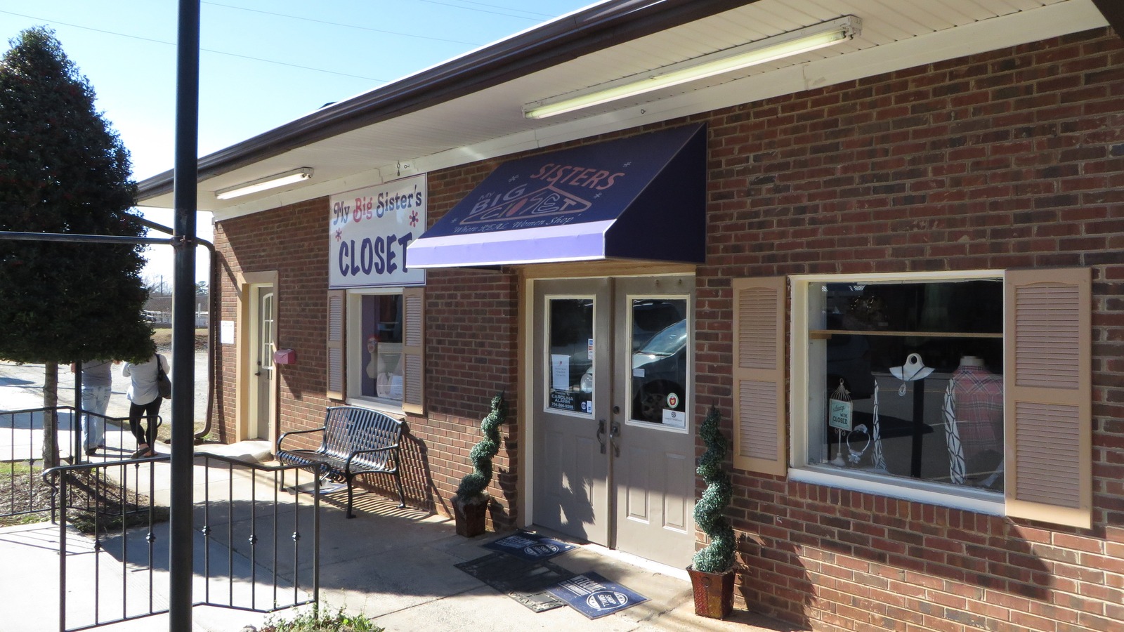 Blue boutique storefront with a purple awning at My Big Sister's Closet in Gastonia