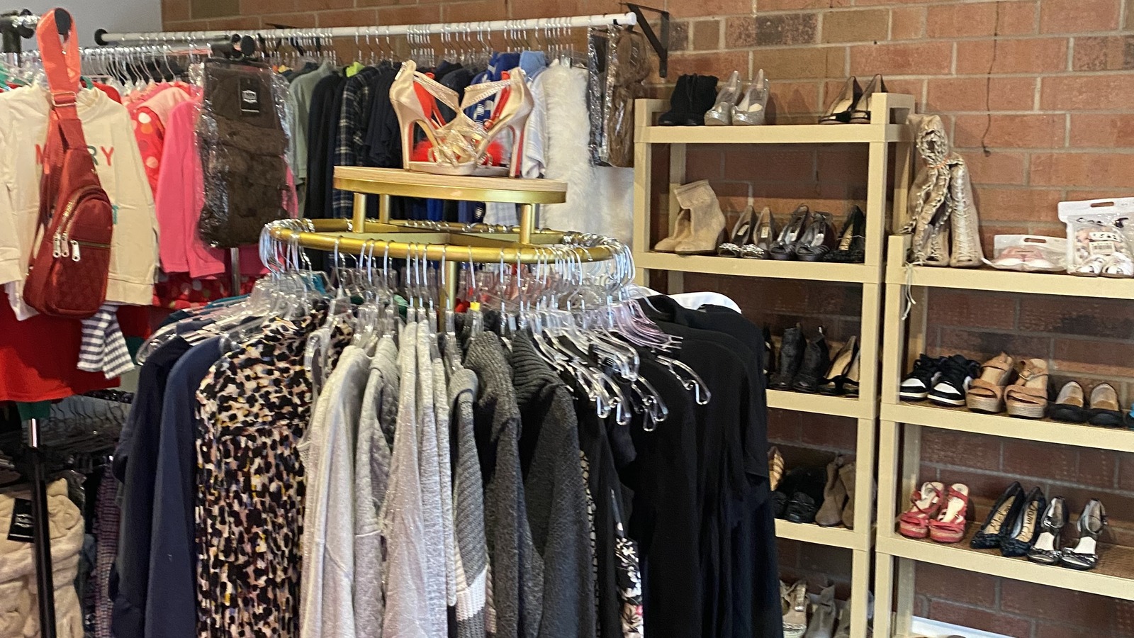 Clothing racks, shoes, and accessories arranged inside Xtasy Deal Store in Gastonia
