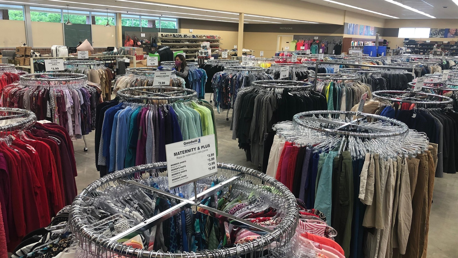 Circular clothing racks beside shelves of pottery and home accents at Goodwill Gastonia
