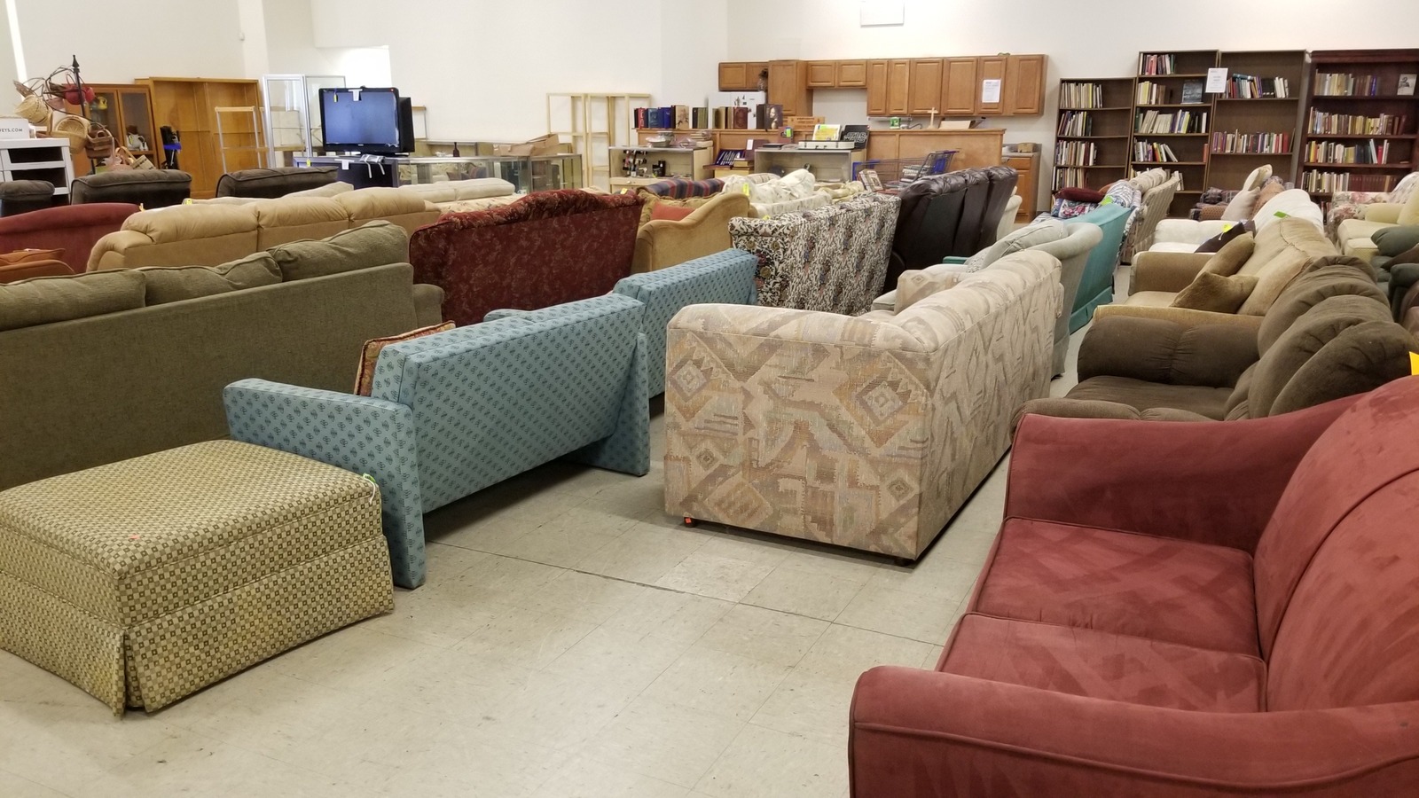 Rows of sofas, tables, shelving, and cabinets across the Gastonia Habitat ReStore furniture floor