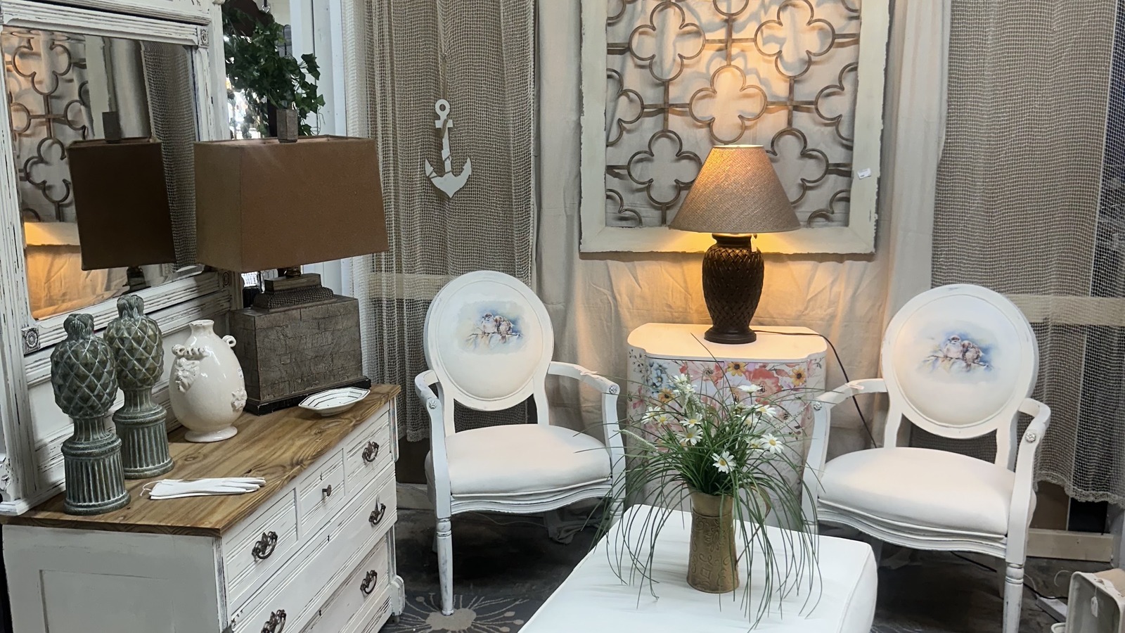 Lamps, chairs, and painted furniture arranged at THRIFTIQUE MARKETPLACE in Gulfport