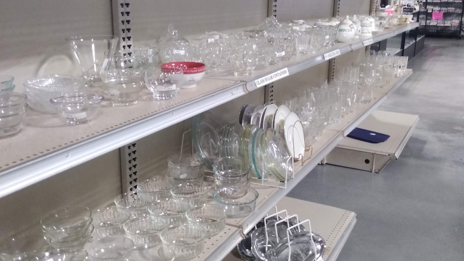 Clear glassware organized along white shelves in Burlington