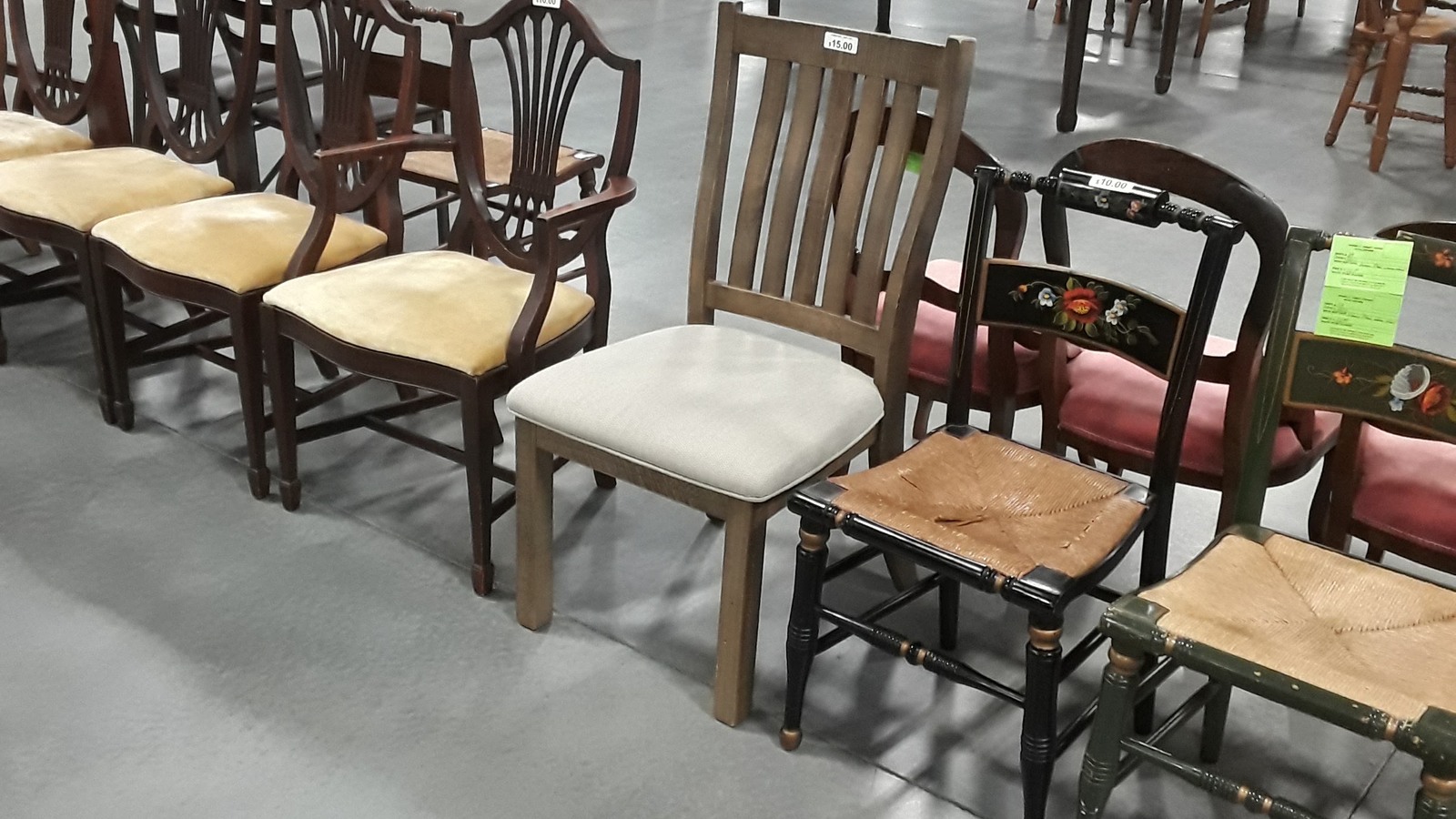 Wooden dining chairs arranged in rows for easy comparison
