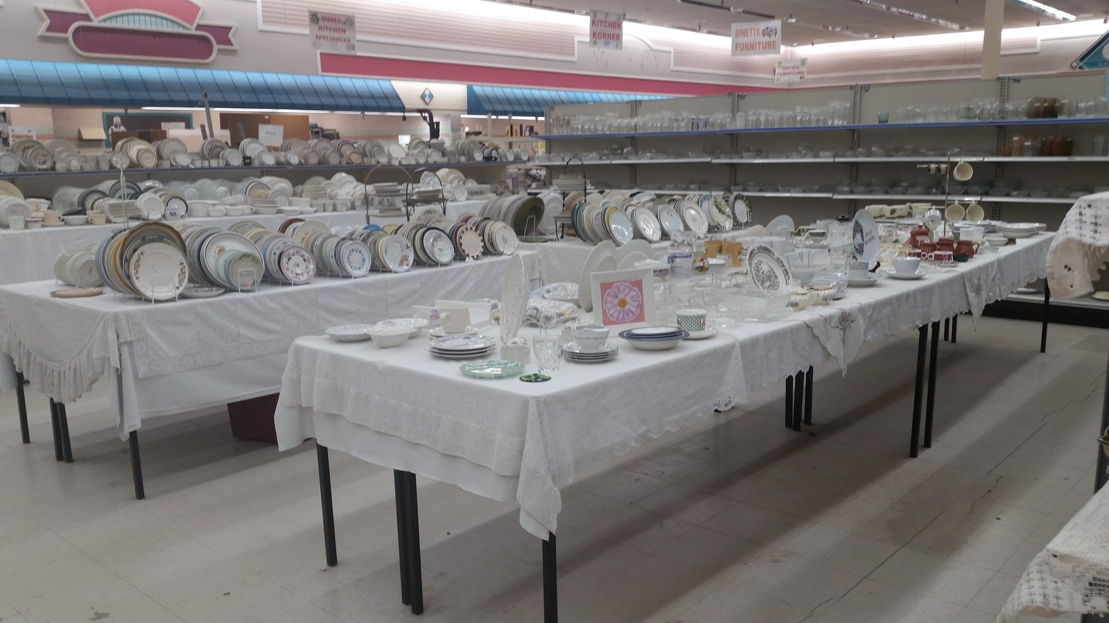 White tablecloths filled with china cups plates and serving pieces
