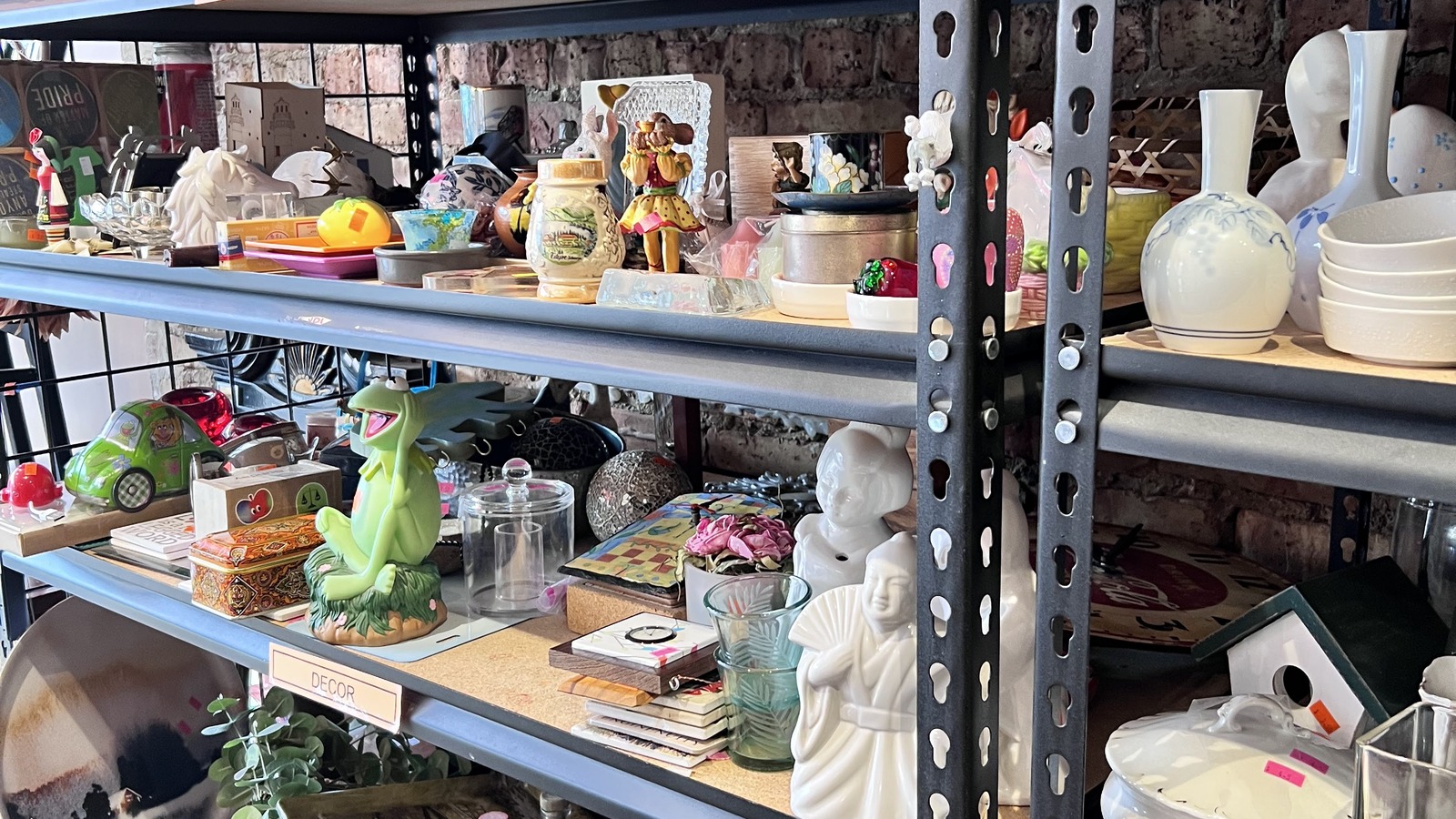 Housewares and decorative pieces filling shelves at Brown Elephant