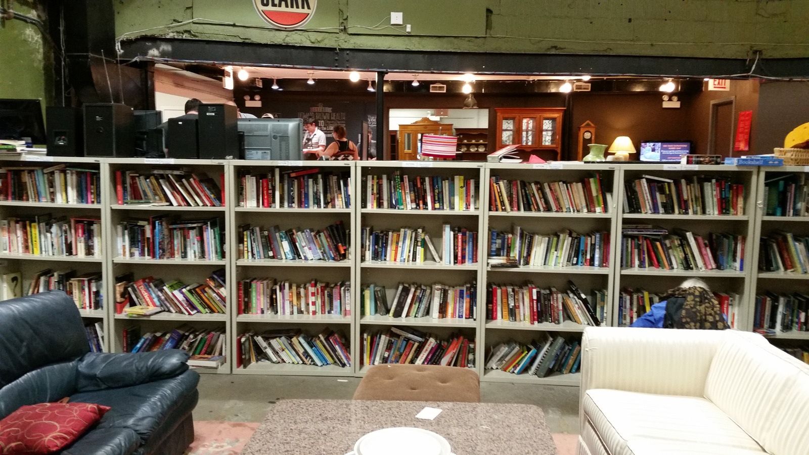 Long book wall and reading chair inside Brown Elephant Andersonville