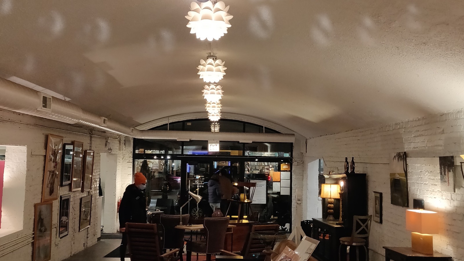 Curated tabletop decor beneath pendant lights at Brown Elephant