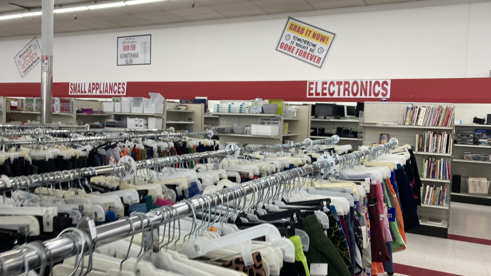 Long clothing racks inside Ohio Thrift Store near Columbus