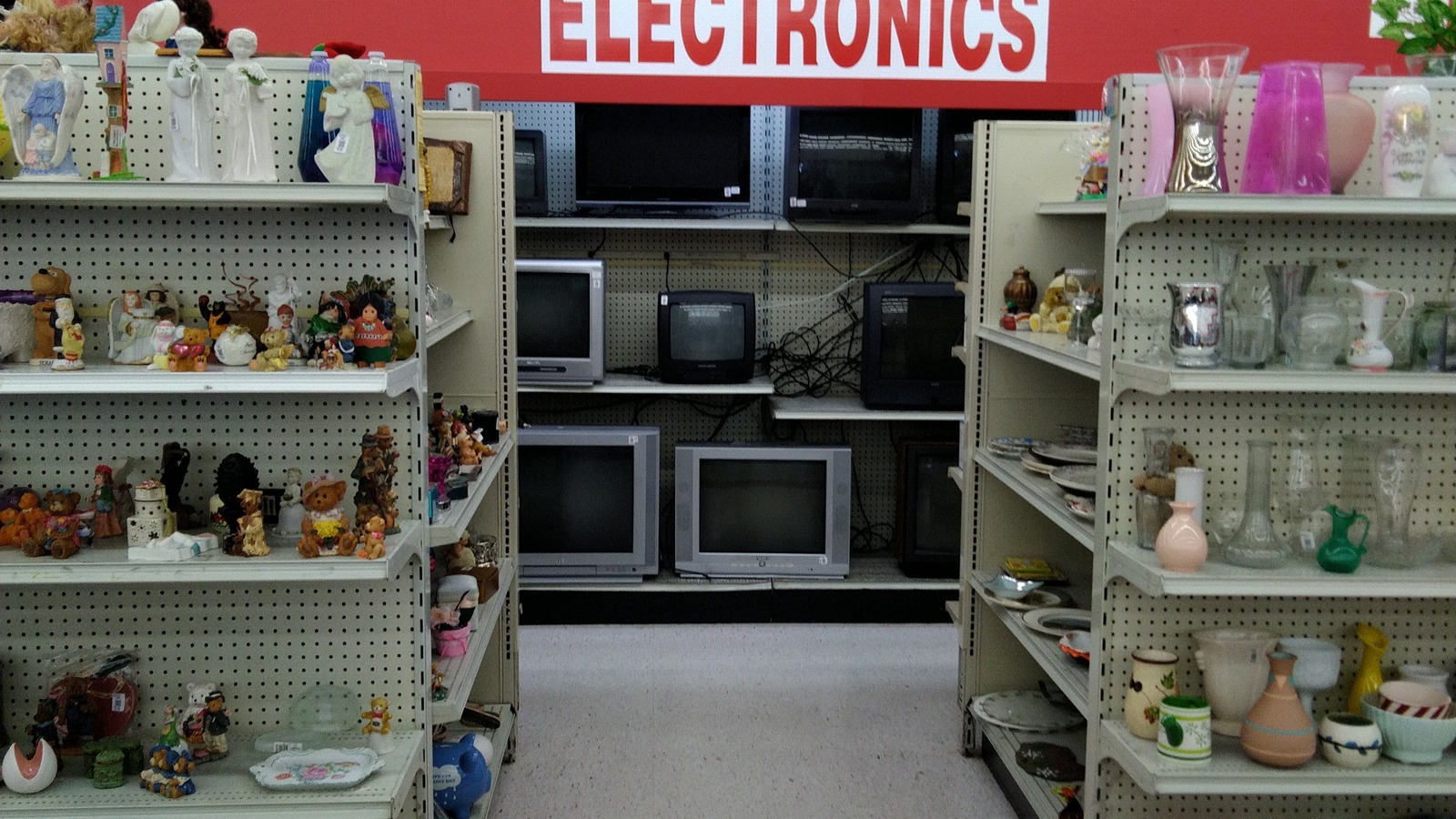 Electronics and small appliances arranged along a wide store aisle