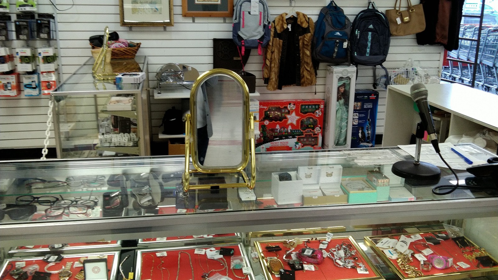 Collectibles and decorative objects arranged inside a glass showcase