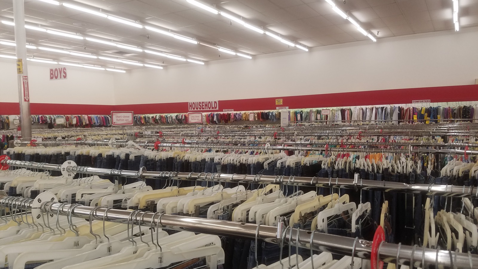 Wide apparel floor with rows of neatly organized clothing