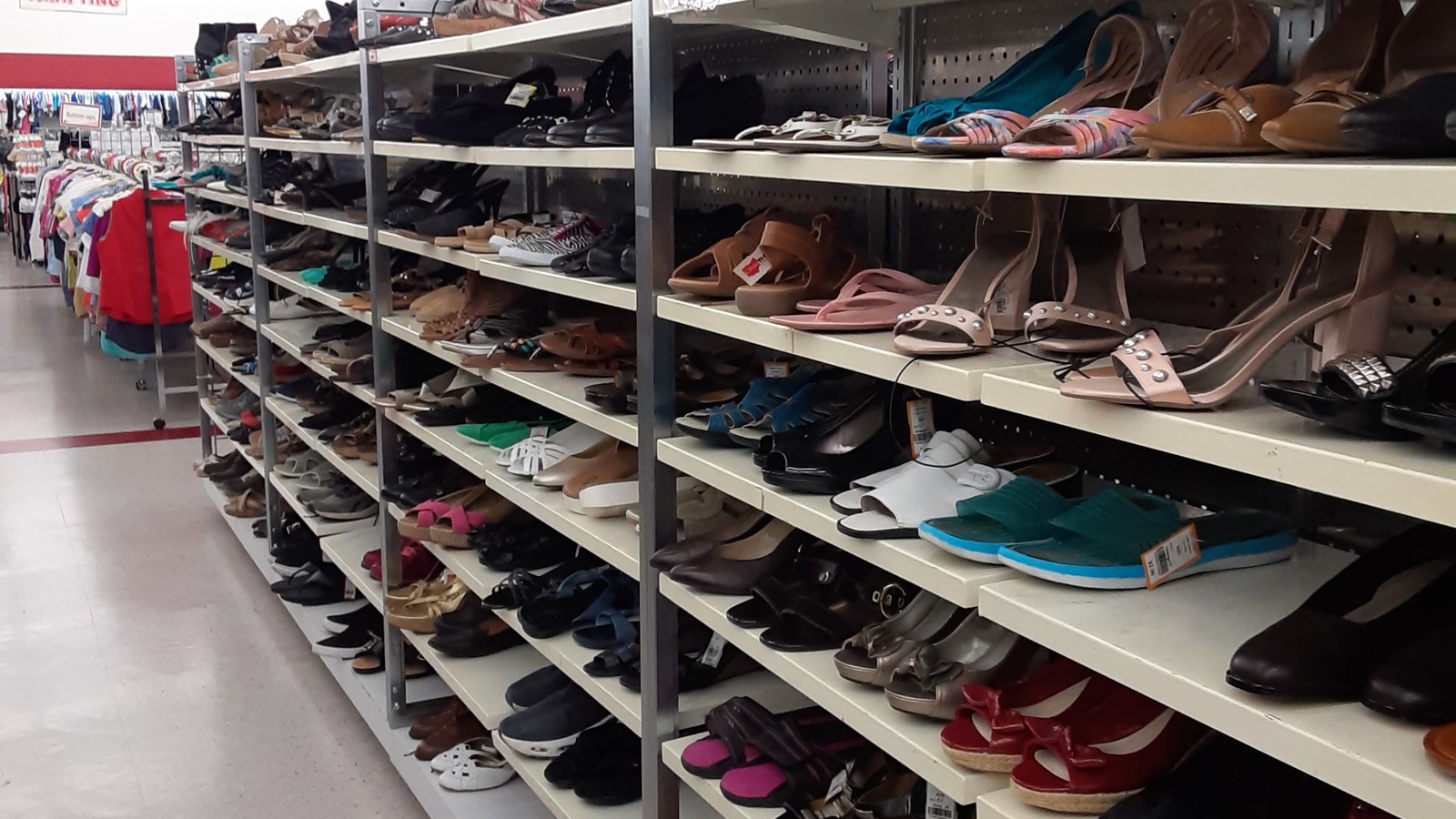 Footwear aisle with shoes sorted across long shelves