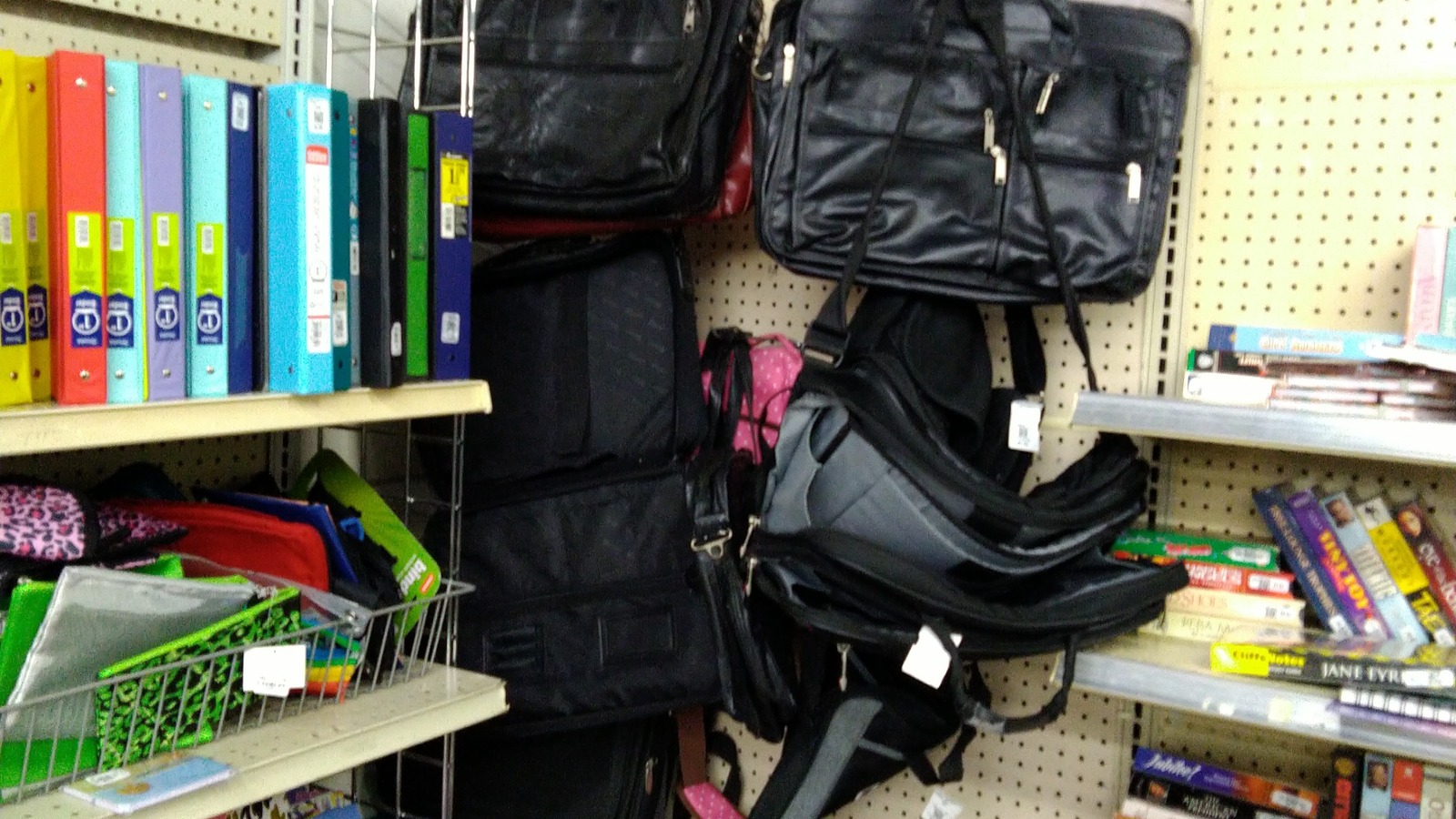 Handbags and backpacks hanging in the accessories department