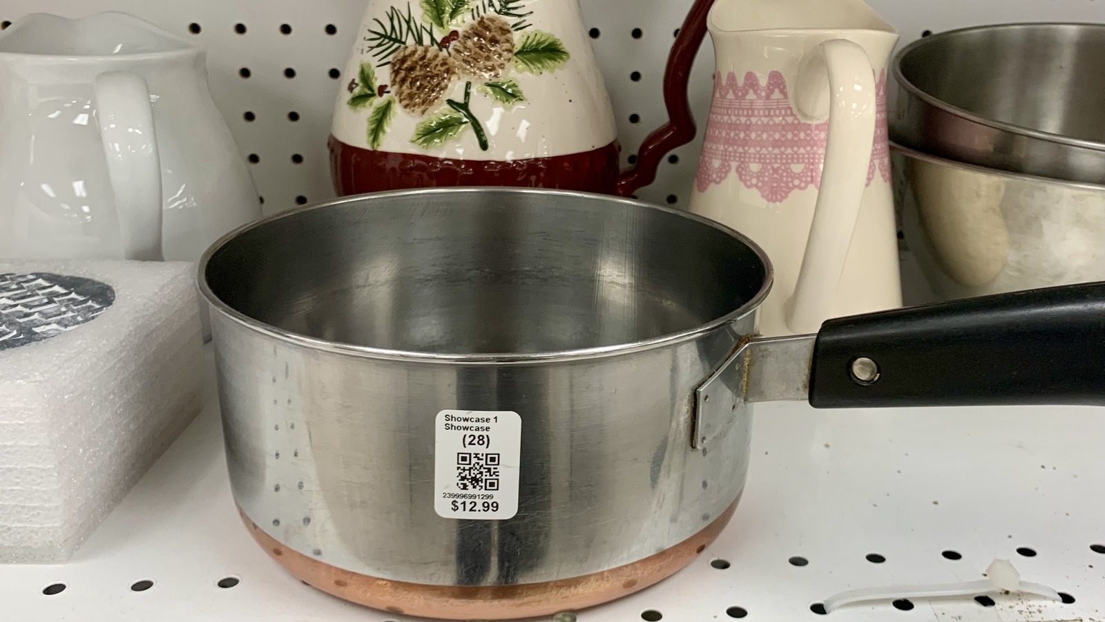Stainless steel cookware beside decorative kitchen pieces